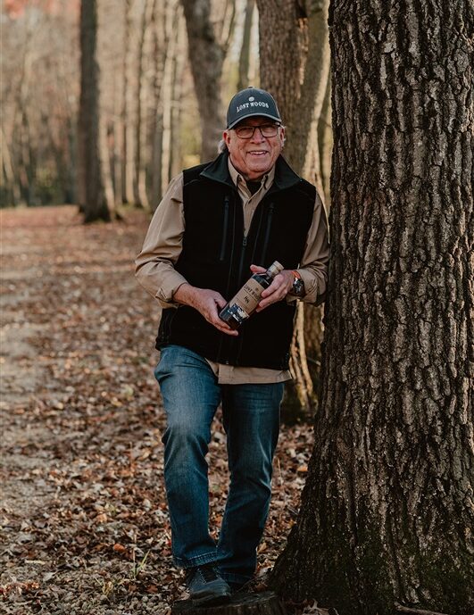 Tom Schaeppi and a Lost Woods bottle in the woods of Minnesota.